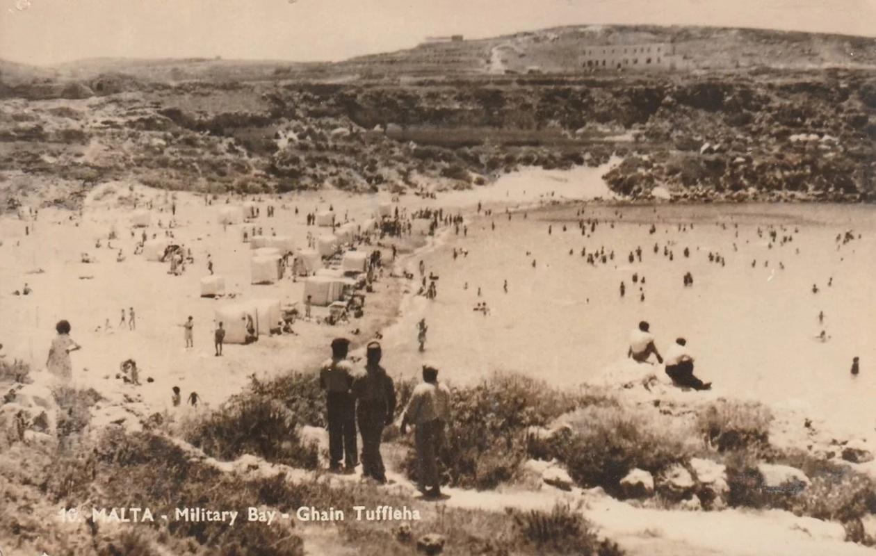 The director of public works accused the military authorities of using the excuse of double loading so as not to take sand from Għajn Tuffieħa (military bay), keeping it in pristine condition for servicemen to enjoy. Photo: Postcard, private collection