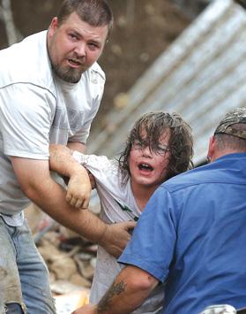 A child calls to his father after being pulled from the rubble of the Tower Plaza Elementary School.