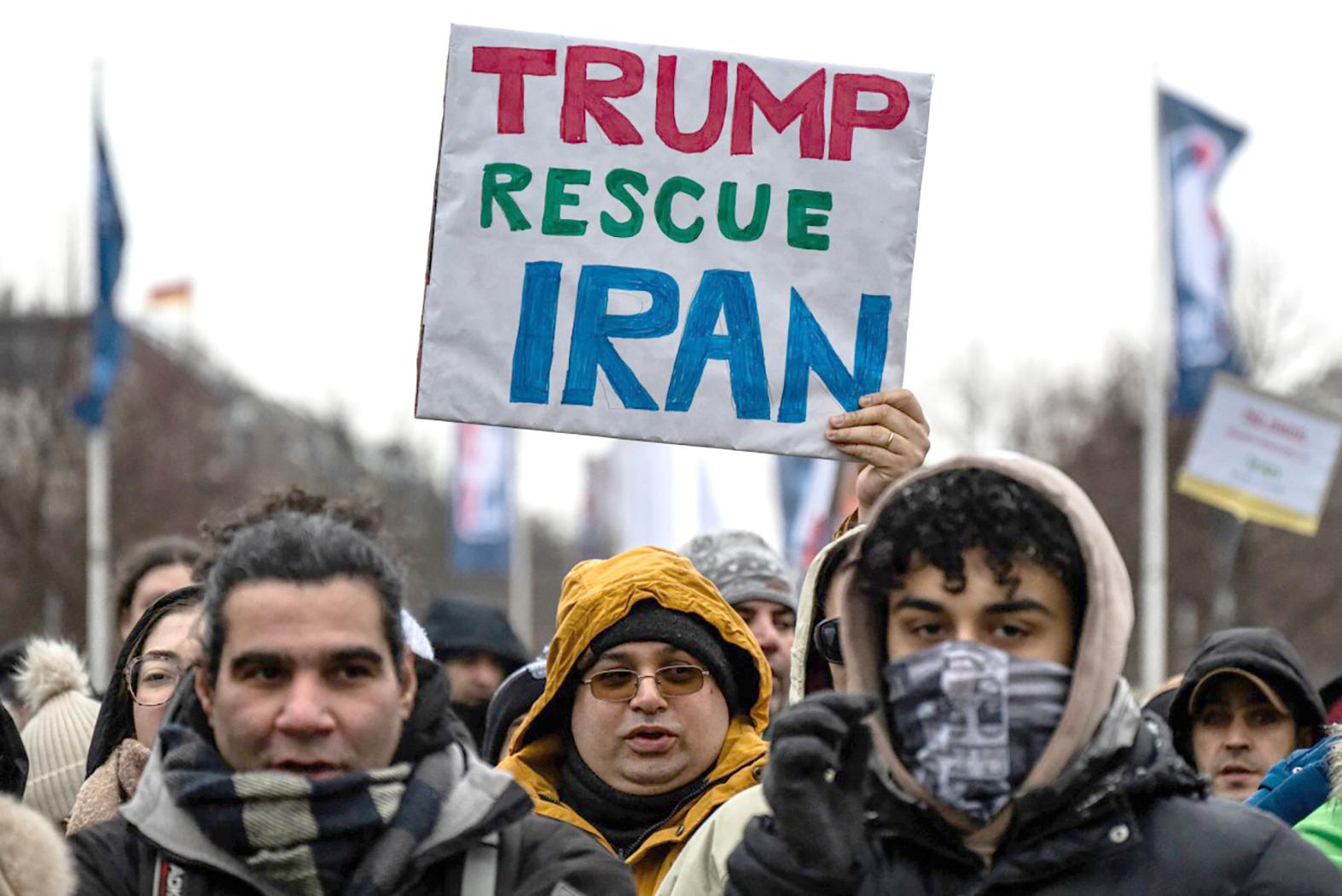 A demonstrator displays a placard calling for the US to intervene in Iran during an anti-Iranian-government protest in Berlin &ndash; a call supported by some Iranians living in Malta. Photo: John Macdougall/AFP