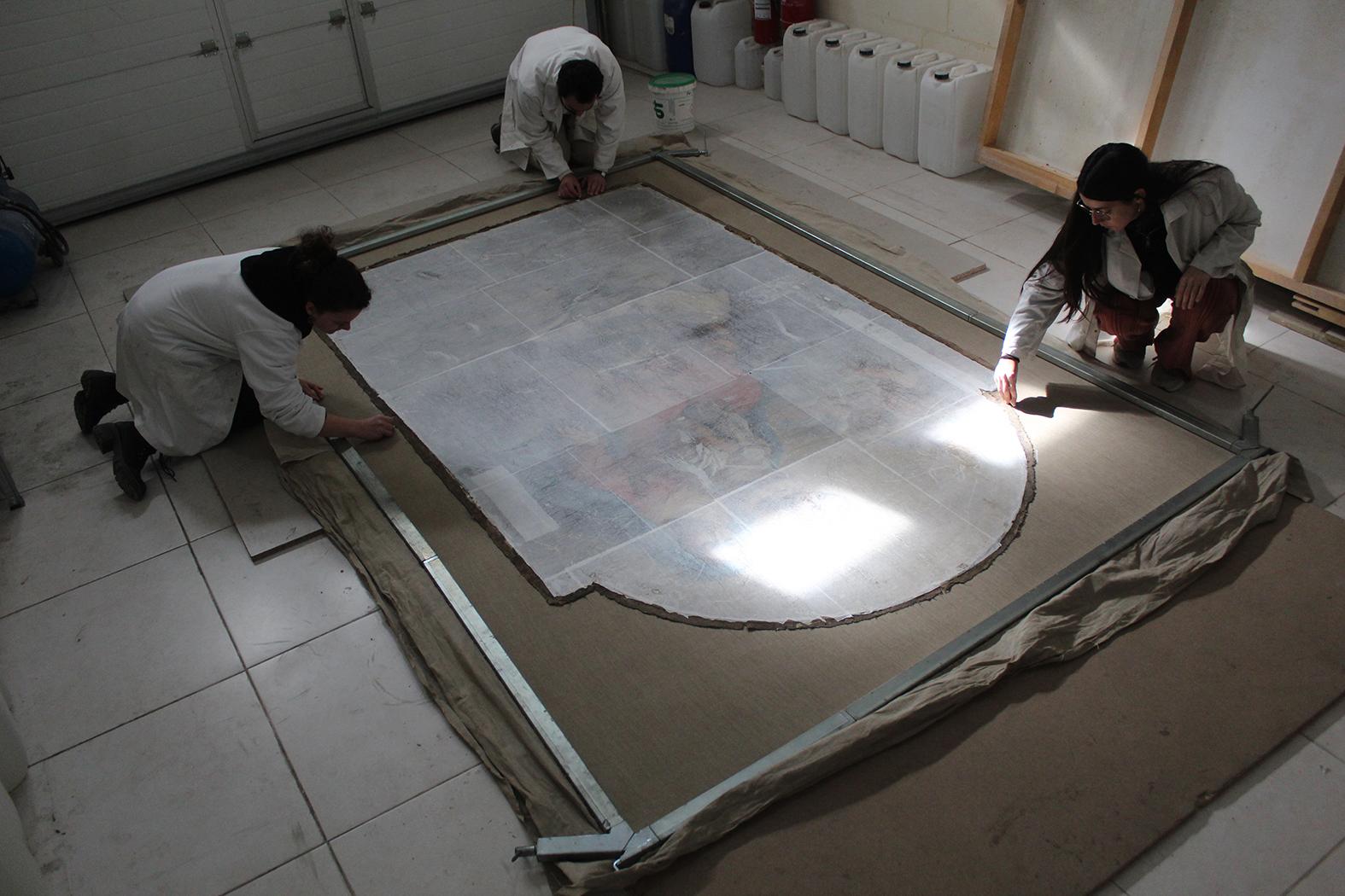 The team at ASC conservation Centre Ltd. preparing for the re-lining procedure which fully stabilised the canvas support. Photo credit: ASC Conservation Centre Ltd.