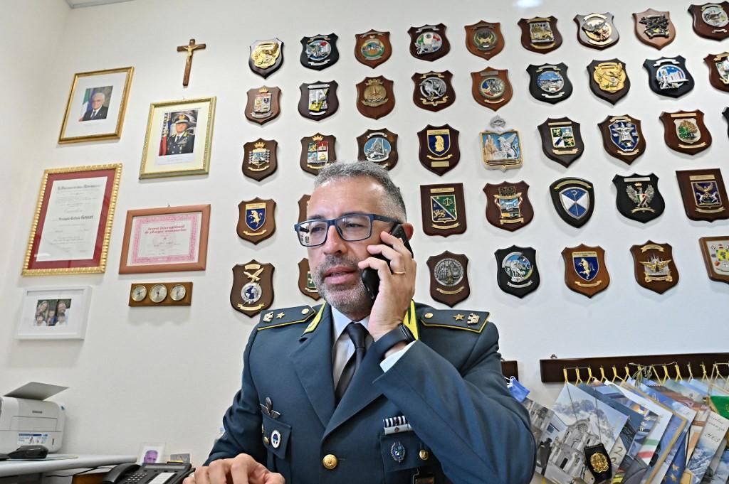 Commander Arcangelo Raffaele Gennari, speaks on his phone while answering questions on illegal harvesting of date mussels in Monopoli.