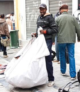 Immigrants sell counterfeit goods in downtown Athens. This new campaign aims to raise awareness on the risks attached to these goods and to stimulate cooperation between stakeholders. Photo: Gabriela Insuratelu
