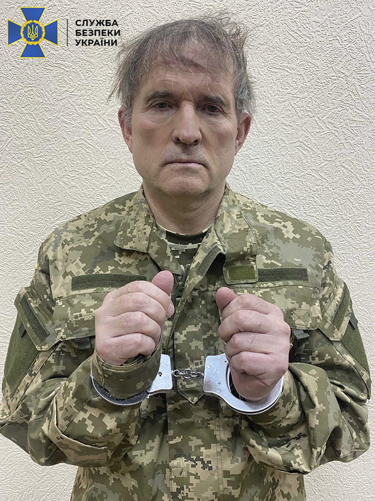 This undated and unlocated handout picture released on April 12, 2022 by the Security Service of Ukraine shows business tycoon Viktor Medvedchuk with his hands in cuffs and dressed in a Ukrainian army uniform. Photo: AFP
