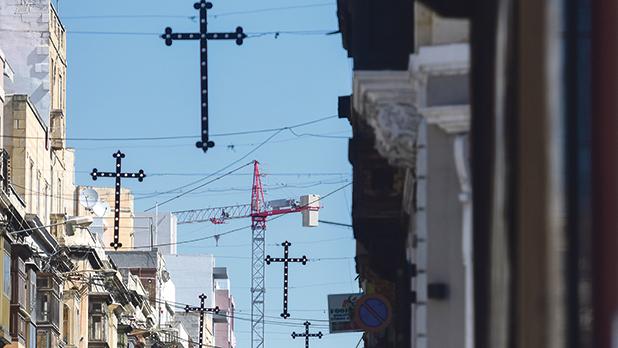 A stark contrast between the cross, which symbolises the crucifixion of Jesus Christ, and tower cranes, considered by many to be the new environmental crosses. Photo: Jonathan Borg