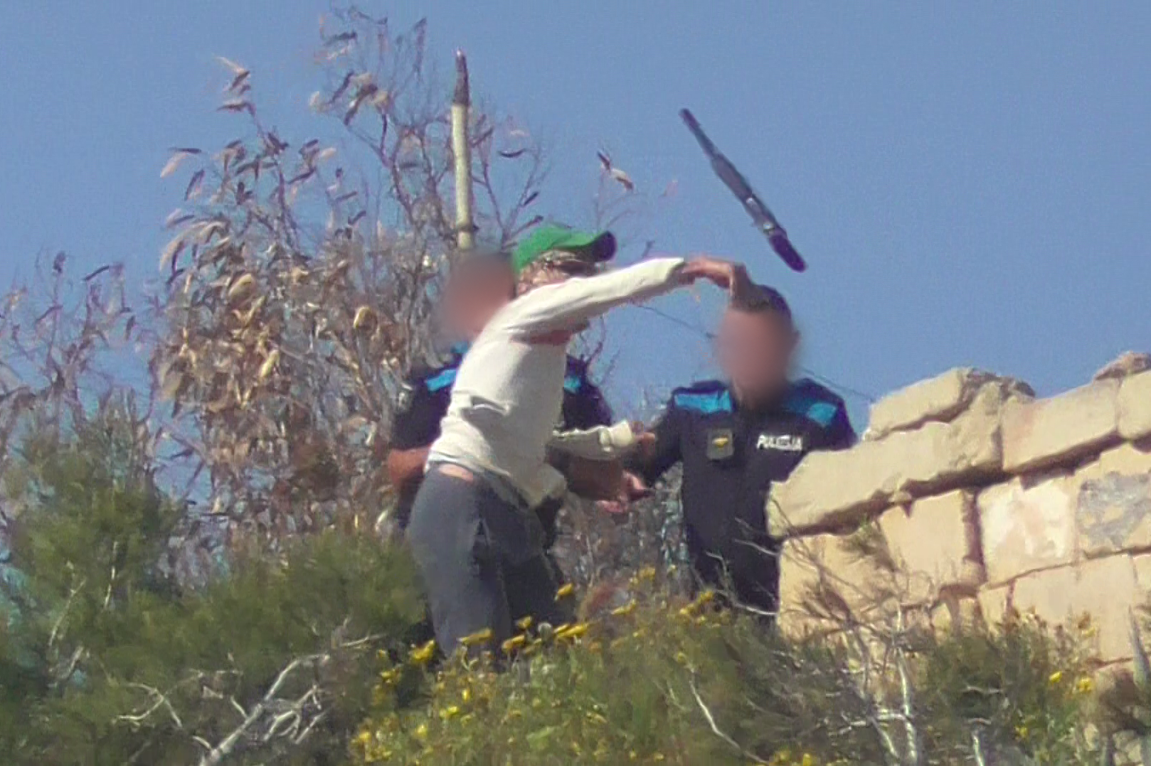 Masked hunter throws gun and attempts to flee EPU officers at Xgħajra on April 18. Photo: BirdLife Malta