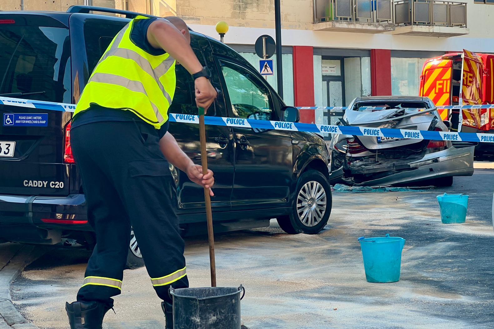 A worker removes an oil spill at the scene of the crash. (Chris Sant Fournier)
