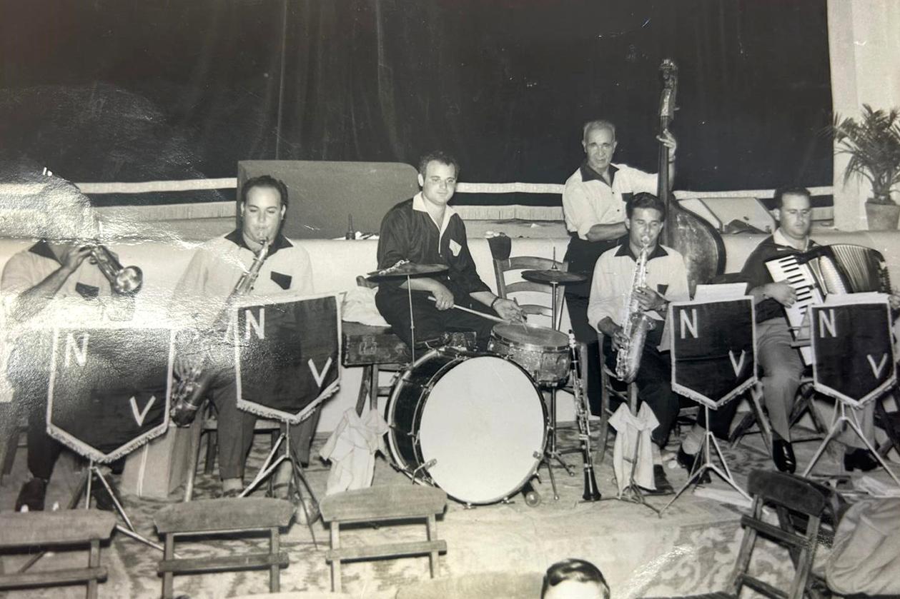 Nazzareno (first from the right) playing the accordion with his band.