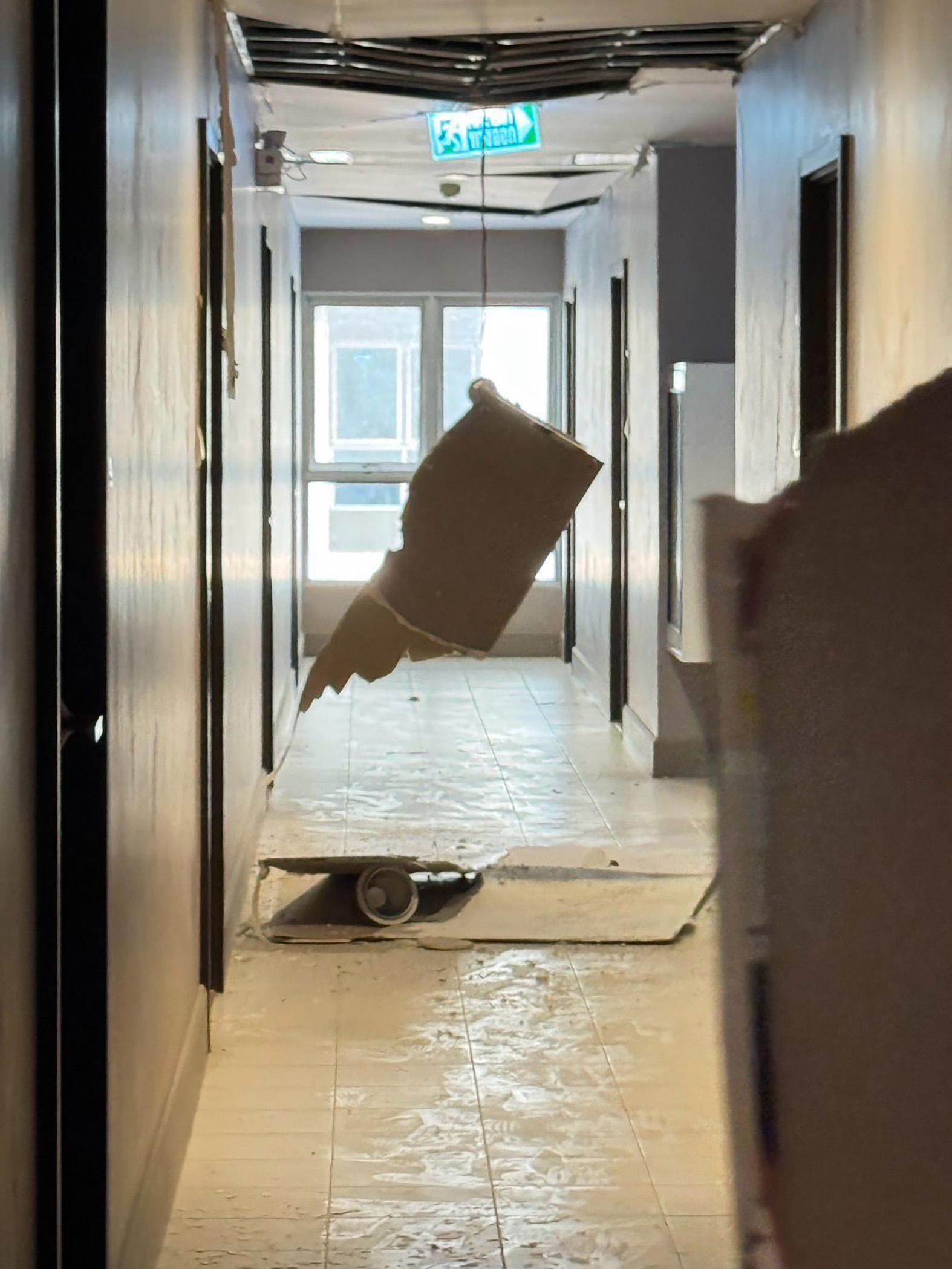 The extensive damage along the corridor outside the couple's apartment.