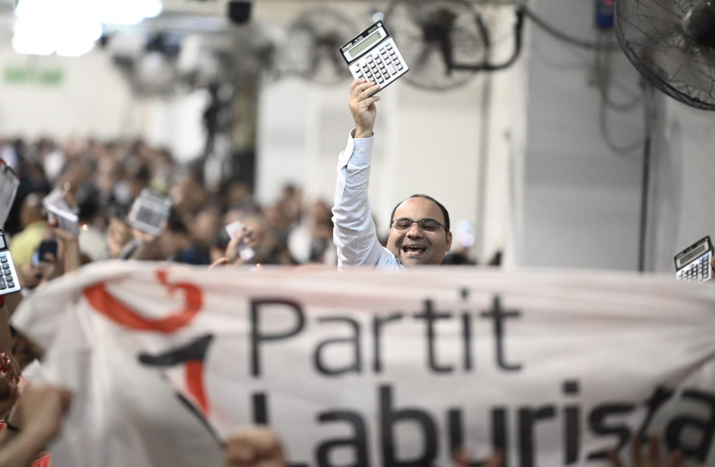 Clyde Caruana celebrates the PL victory, with his famous calculator. Photo: Matthew Mirabelli