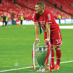 Bastian Schweinsteiger keeping a strong, firm grip on the Champions League trophy.