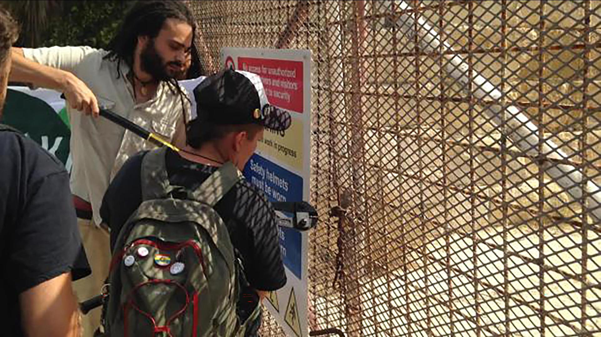 <em>Moviment Graffitti</em> activist Andre Callus breaking the locks at Manoel Island in 2016.