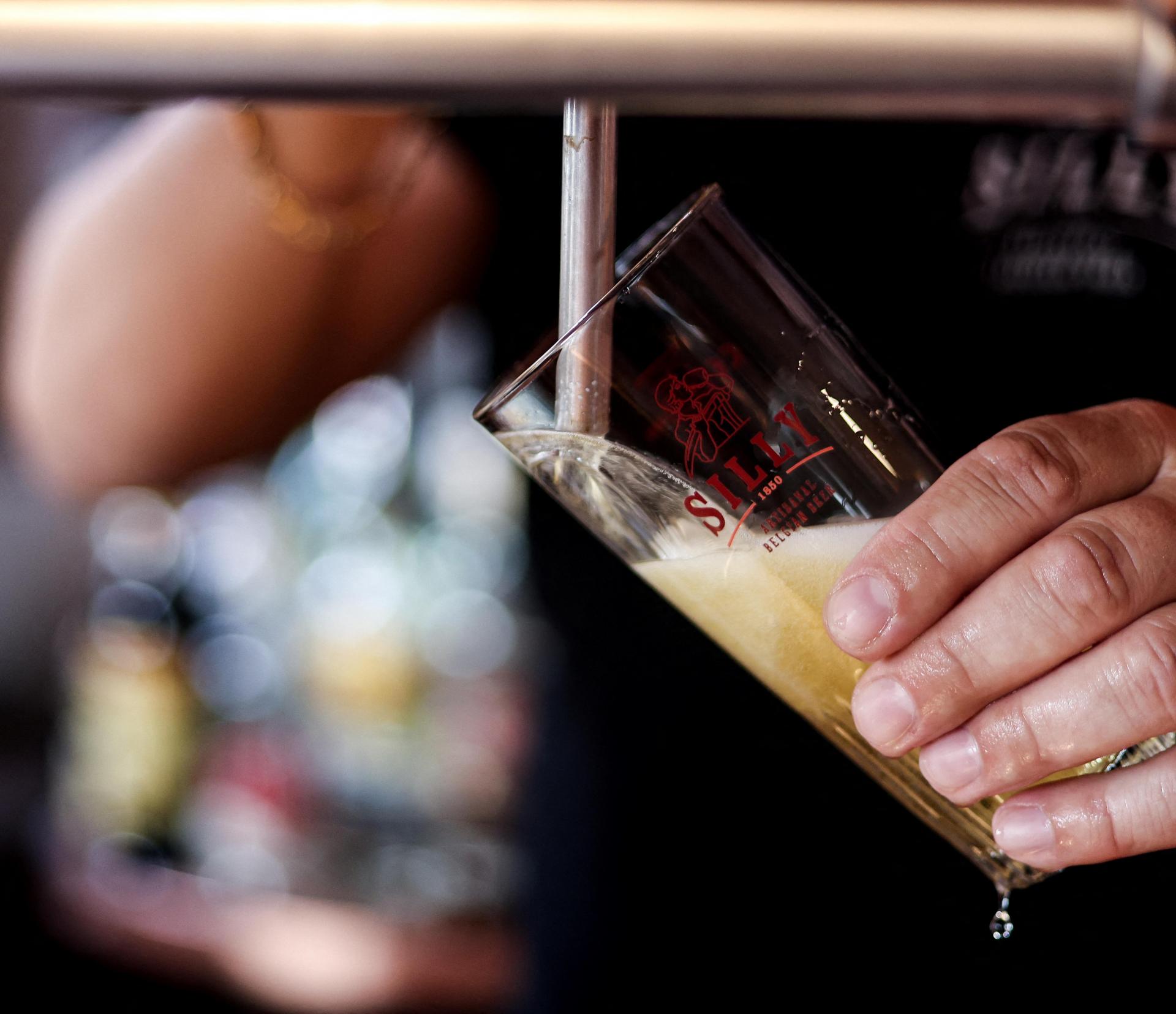 Sebastien Weverbergh, manager of the Caf&eacute; de la Brasserie prepares his bar for reopening and checks the equipment and beer faucet or tap handle.