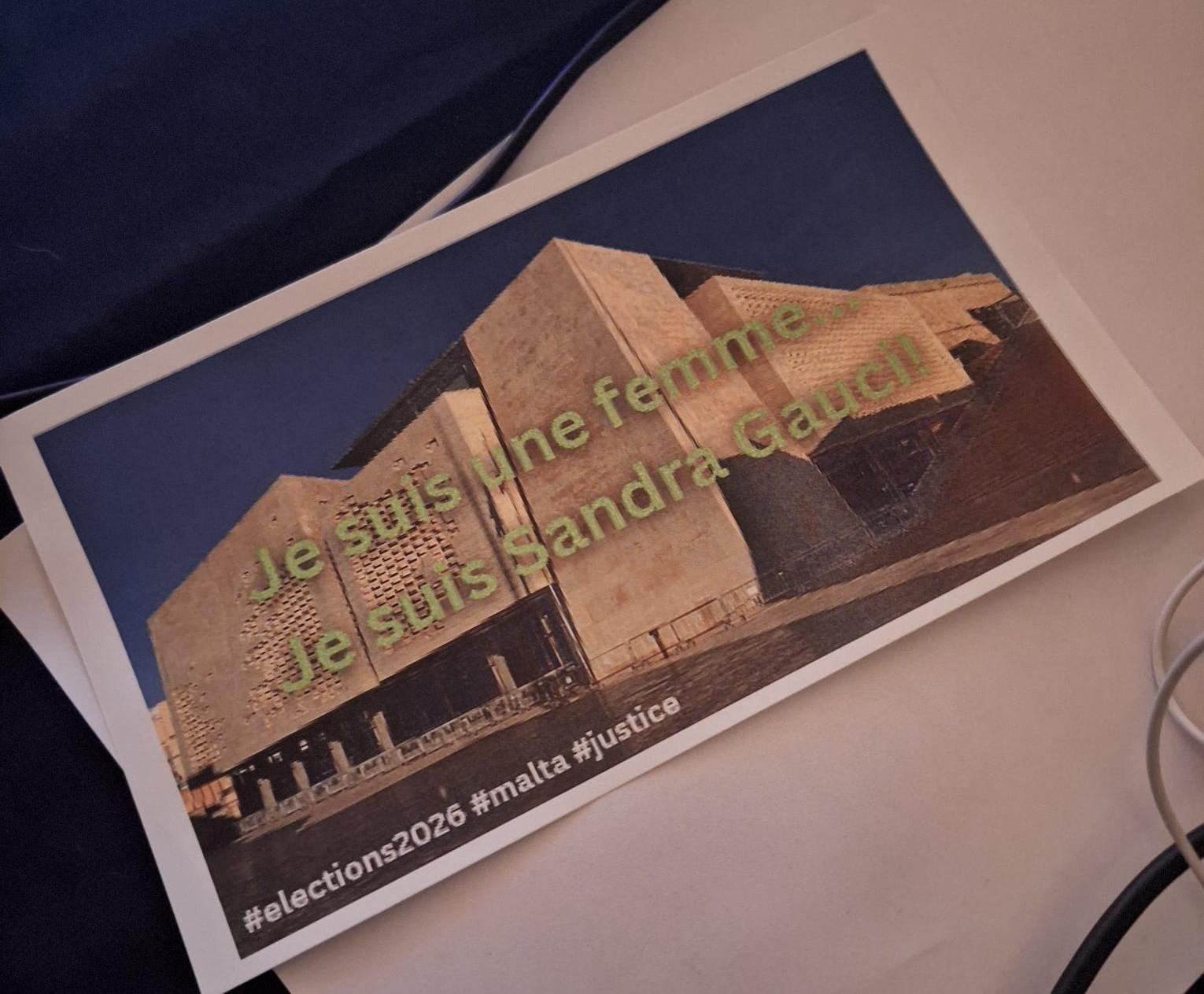 The card carried by Sandra Gauci and supporters during the debate Photo: Emma Borg