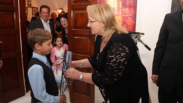 Kyle Saliba presenting a rose to the President.