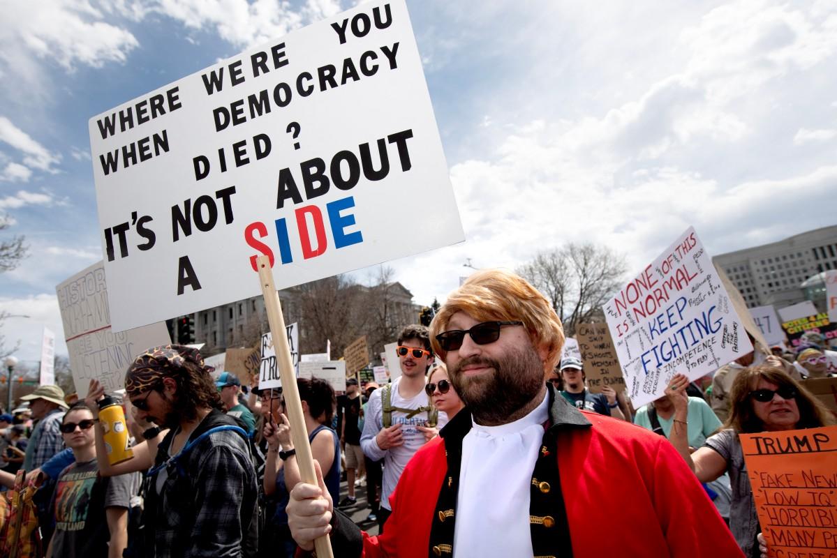 Demonstrators hold signs as they march during the "No Kings" national rally in Denver, Colorado. Photo: AFP