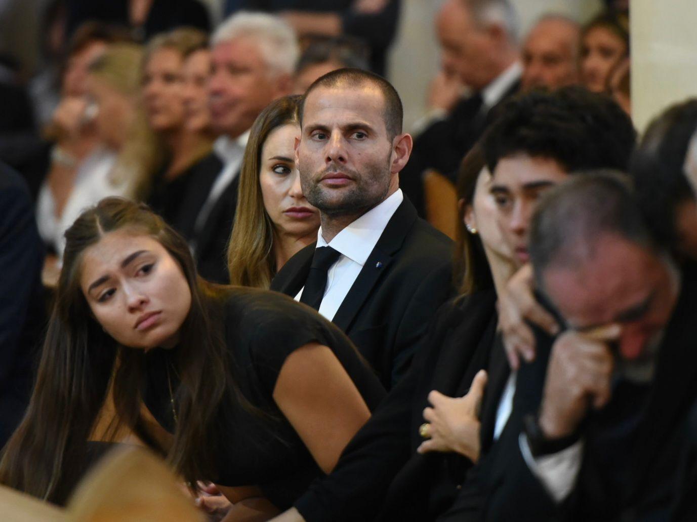 The Prime Minister looking over at the grieving family Photo: Chris Sant Fournier