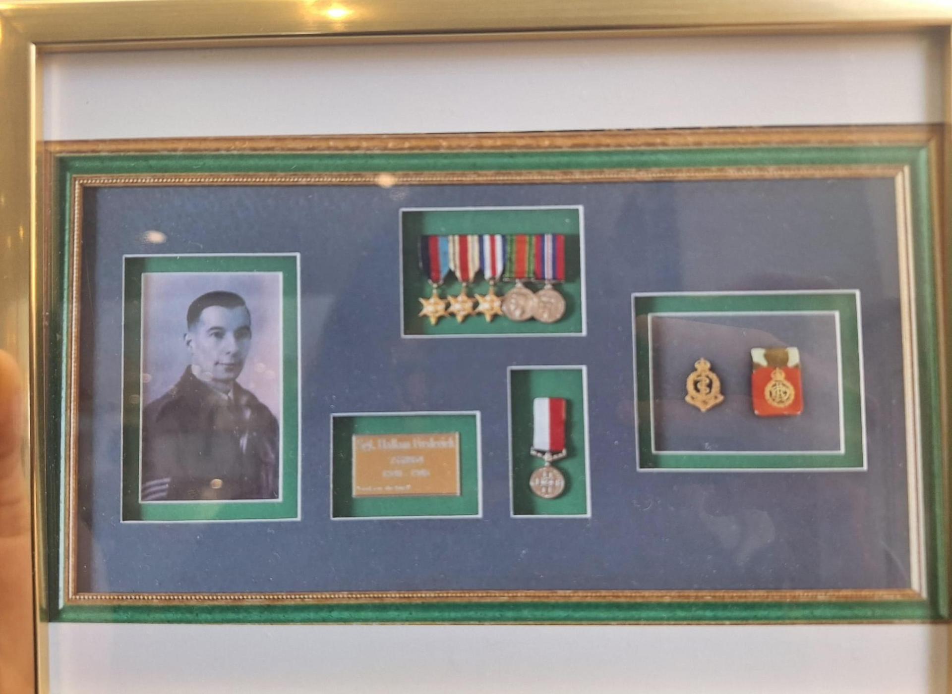 Fred Hallam in a framed photograph along with some of his army medals. Photo: Rob Hallam