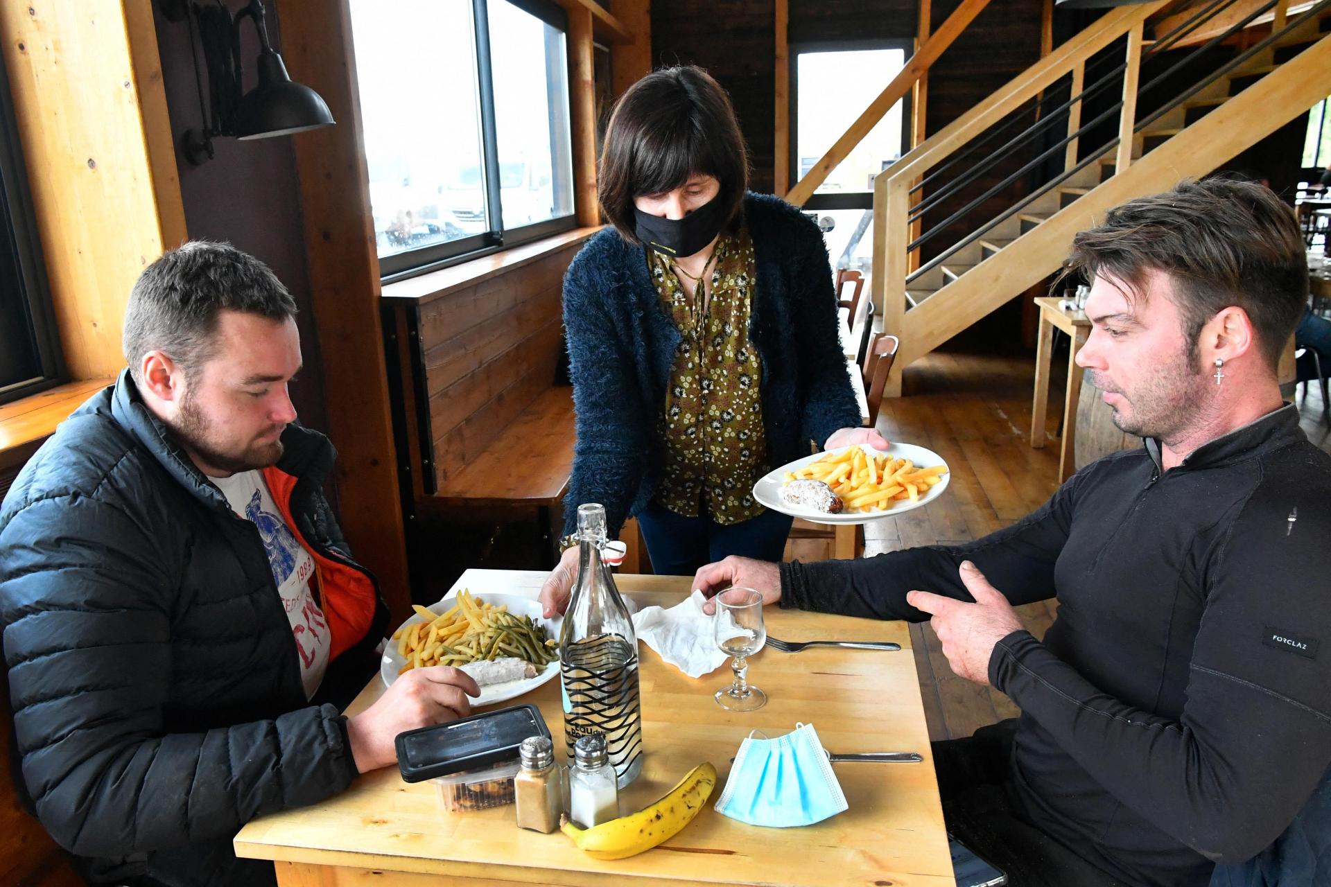 Construction workers lunch in the Mc Guigan&rsquo;s restaurant in Ploudaniel, western France, on February 3, 2021, as few restaurants are open for construction workers only, amid the COVID-19 pandemic.