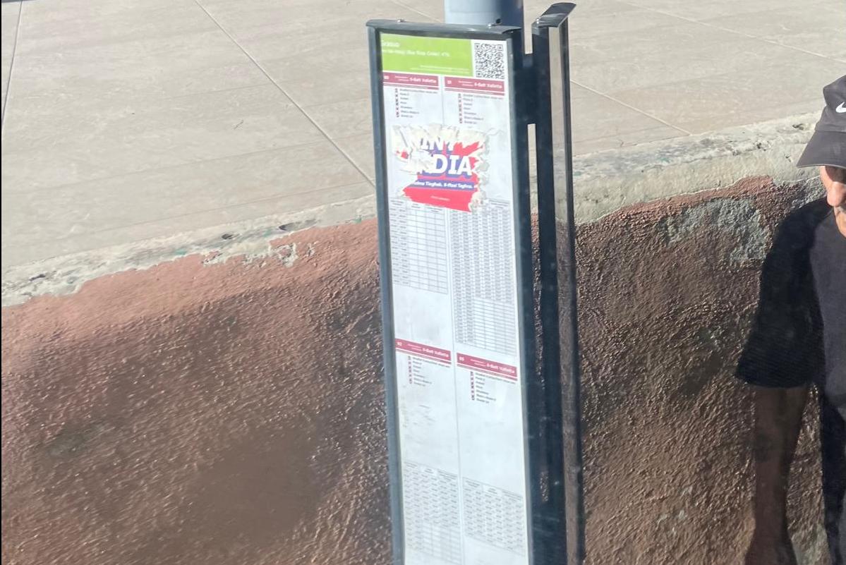 Int India sticker at a bus stop in Paola.