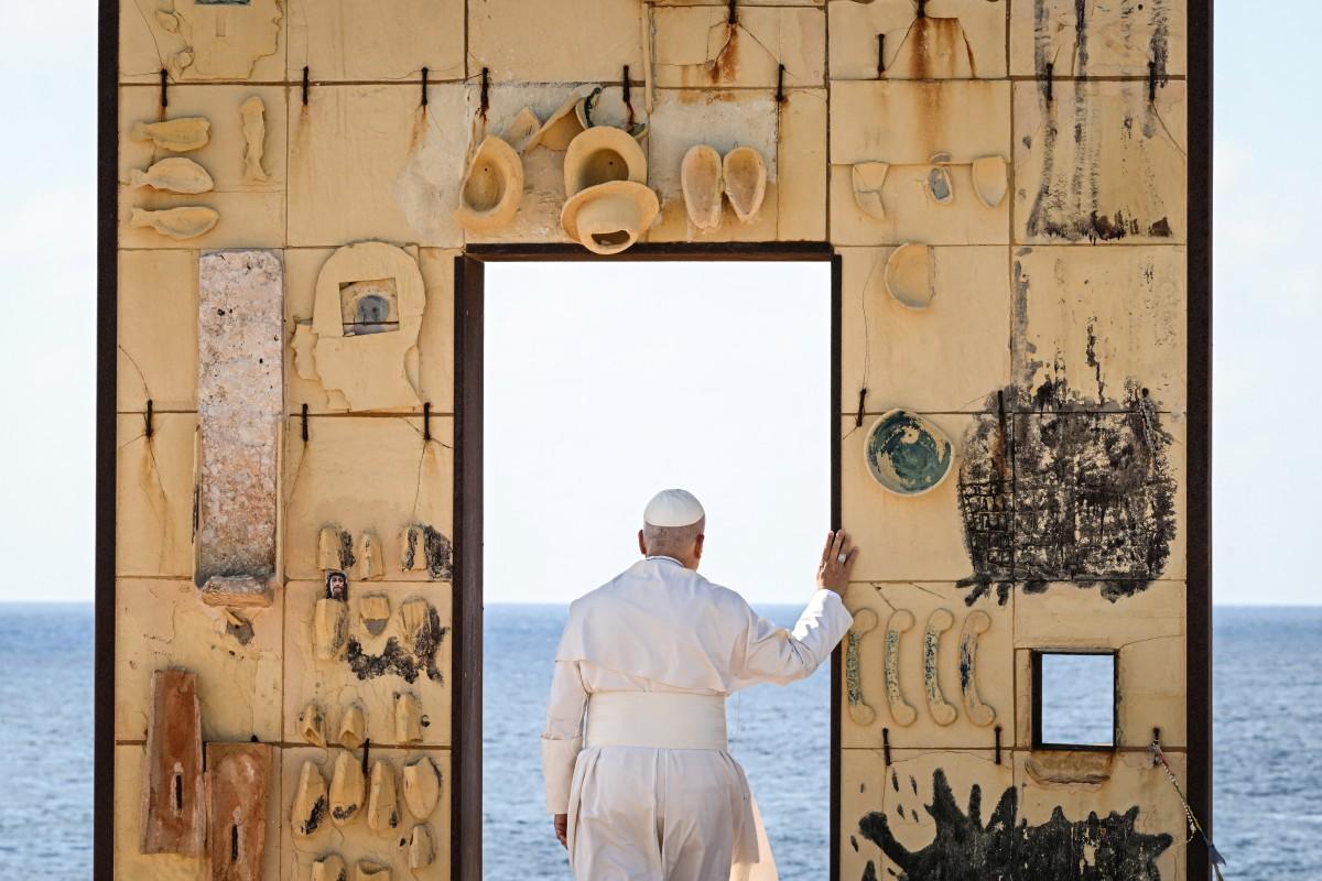 Pope Leo XIV walks trough the arch of the monument Door of Europe - Porta d'Europa made by the italian artist Mimmo Paladino, during a one day visit to Lampedusa island, south of Sicily, on July 4, 2026. Photo: AFP