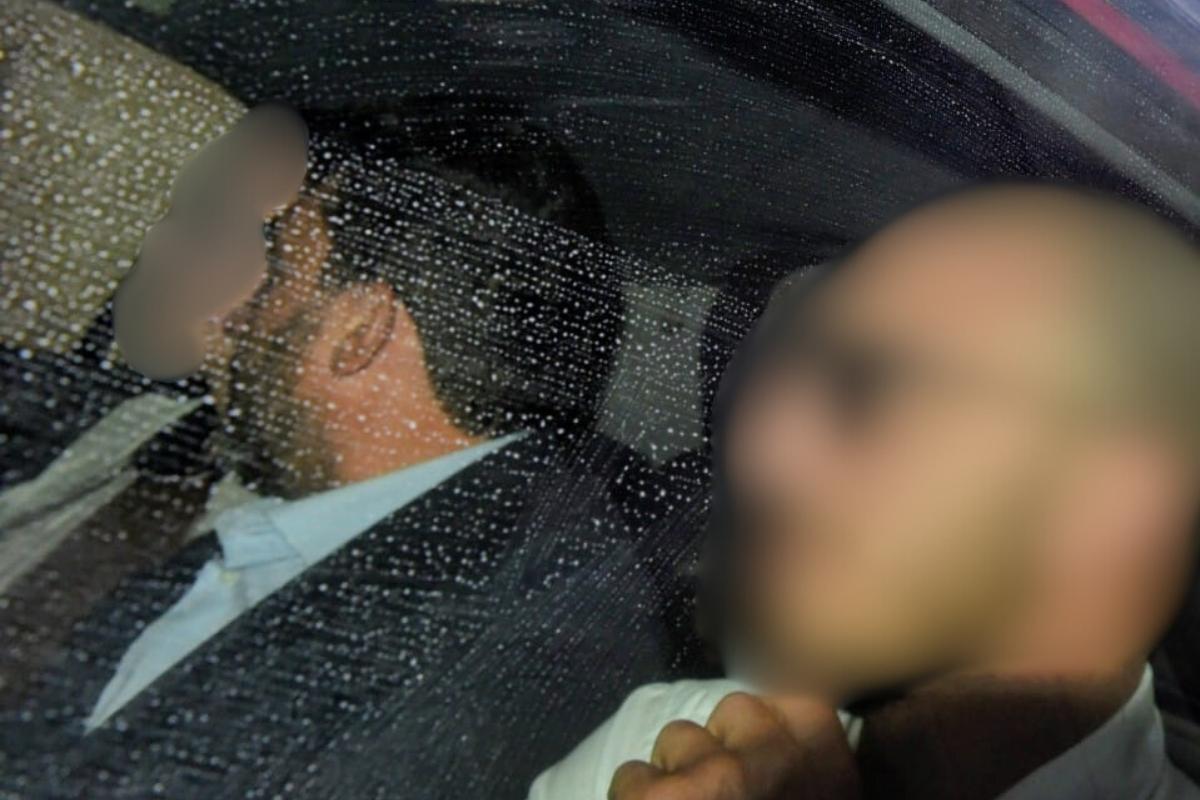 The accused, pictured centre, arrives in court under police escort. Photo: Chris Sant Fournier
