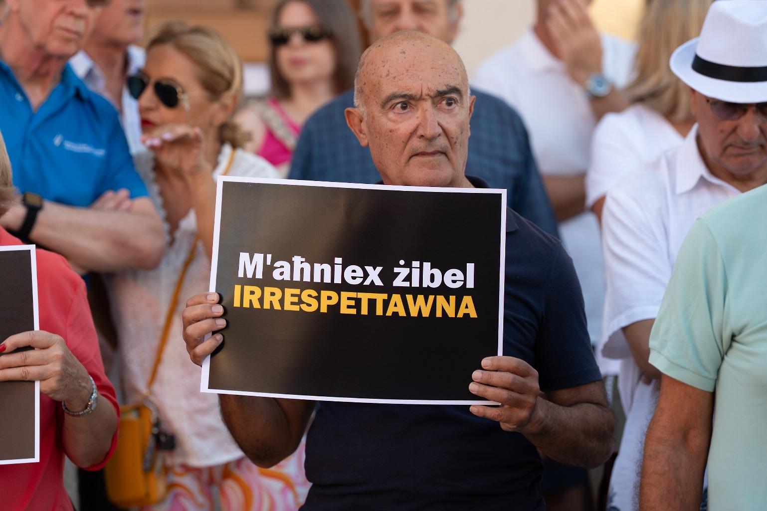 Carmel Asciak, Momentum's Treasurer, holding a placard saying: We aren't trash, respect us Photo: Matthew Mirabelli