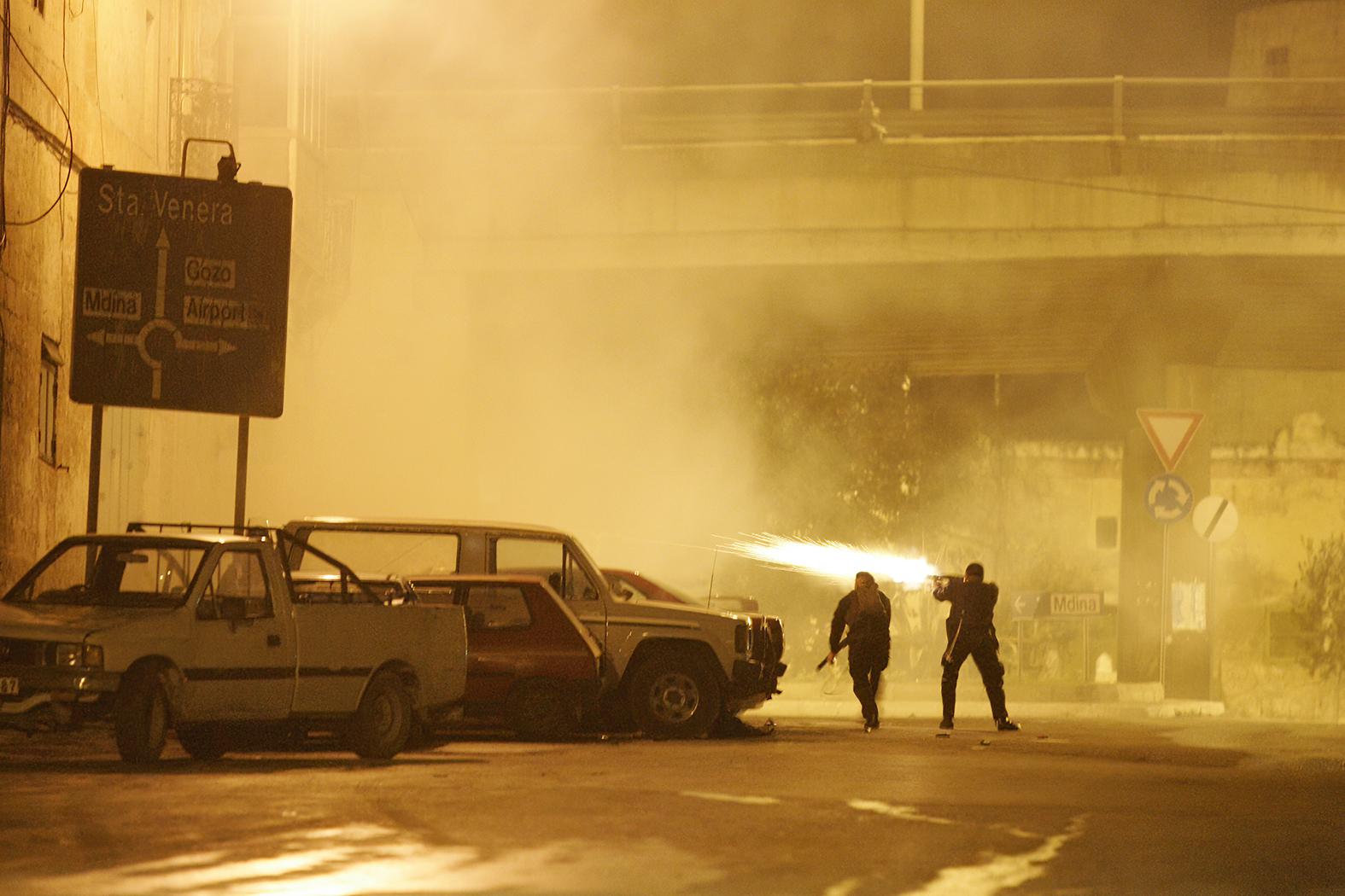 Police officers discharge their firearms during an incident in Qormi.