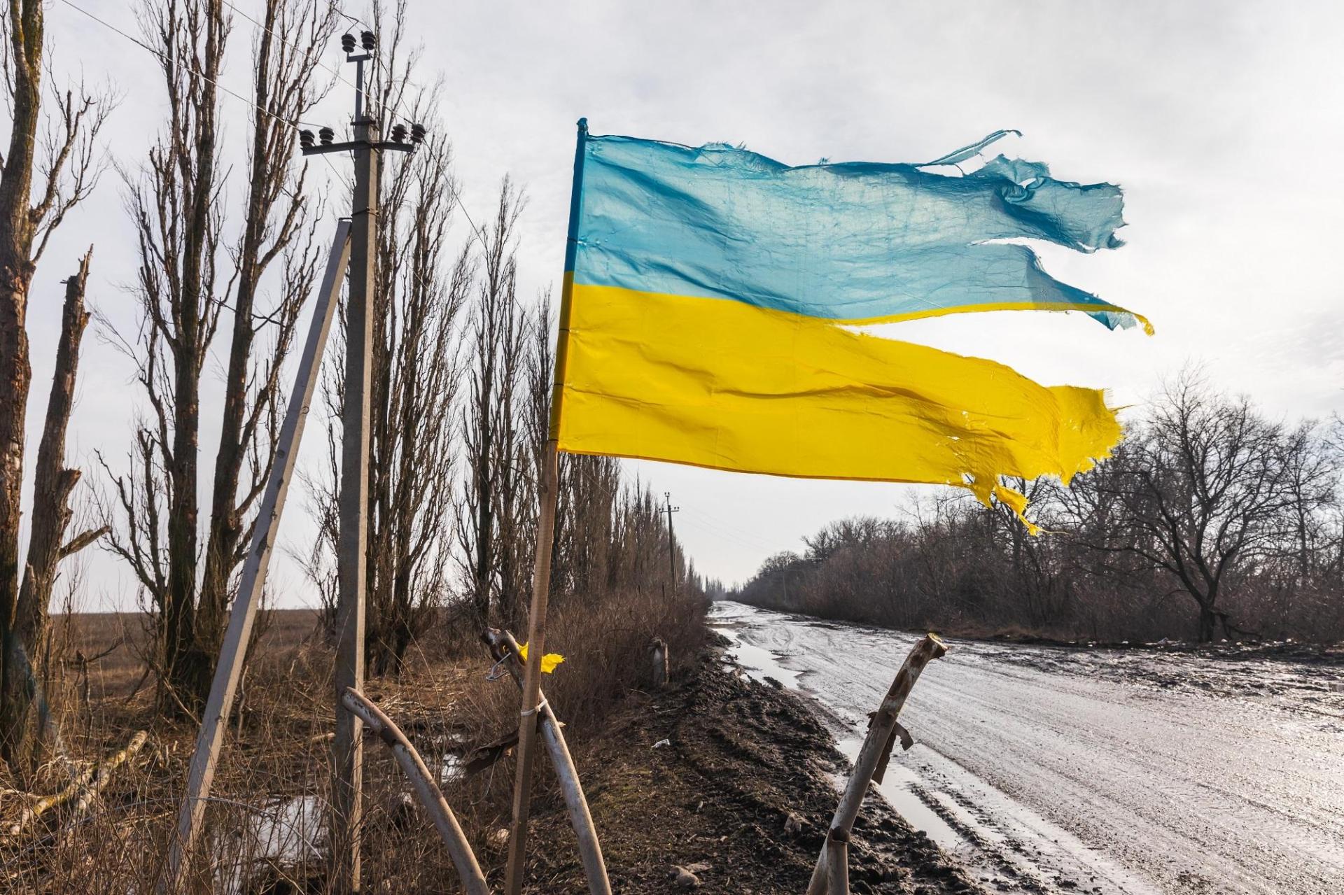A torn but proudly flying flag is seen along a road in the Donetsk region, a symbol of an invincible free Ukraine. Photo: Shutterstock