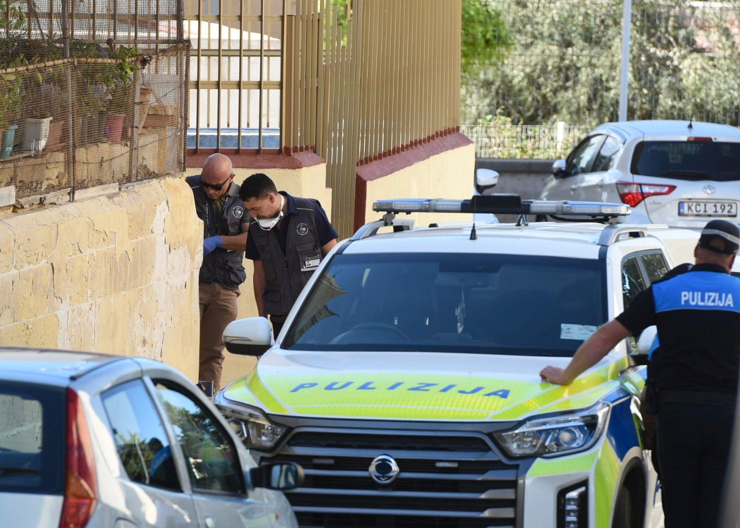 Police officers take a close look at the scene of the shooting. Chris Sant Fournier.