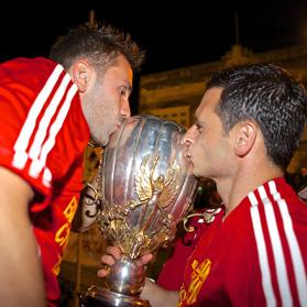 Gareth Sciberras (right) and Paul Fenech kiss the BOV Premier League trophy during Birkirkara&rsquo;s celebrations on Saturday.