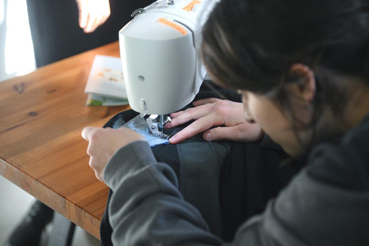 One of the participants fixing a cardigan.