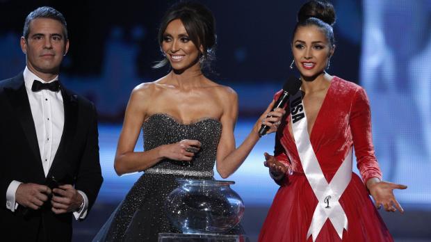 Miss USA Olivia Culpo (R) competes in the question portion of the Miss Universe pageant with hosts Andy Cohen and Giuliana Rancic at Planet Hollywood Resort and Casino.