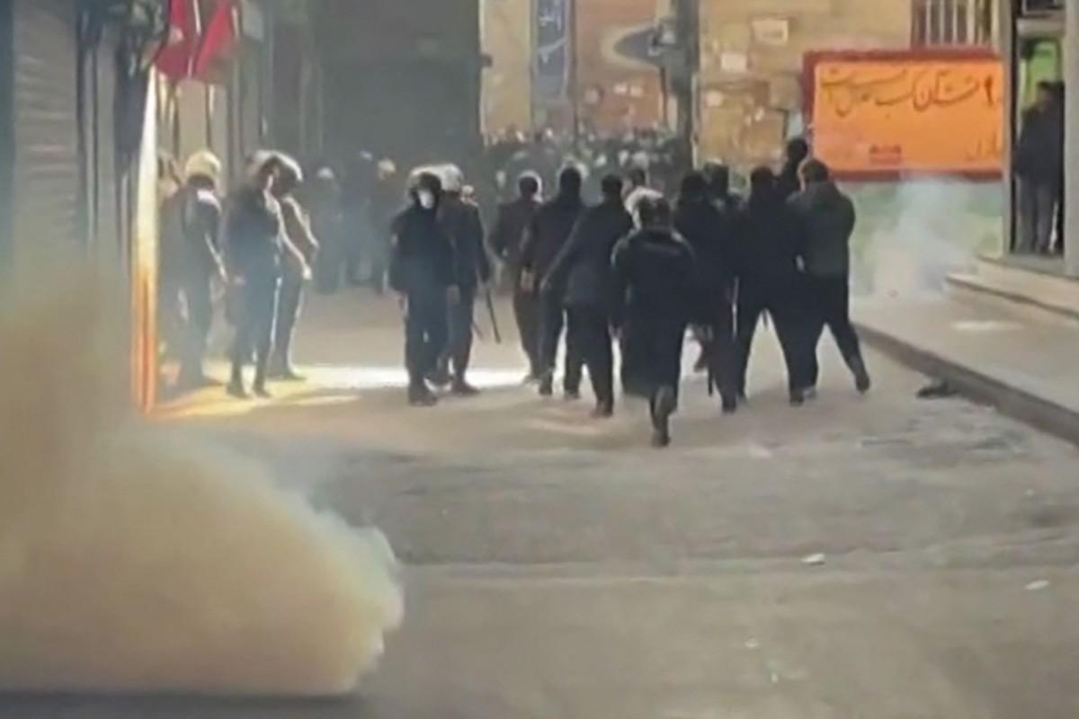 This grab taken on January 6, 2026, from UGC images posted on social media the same day shows Iranian security forces using tear gas to disperse protesters at the Tehran bazaar. Photo: AFP