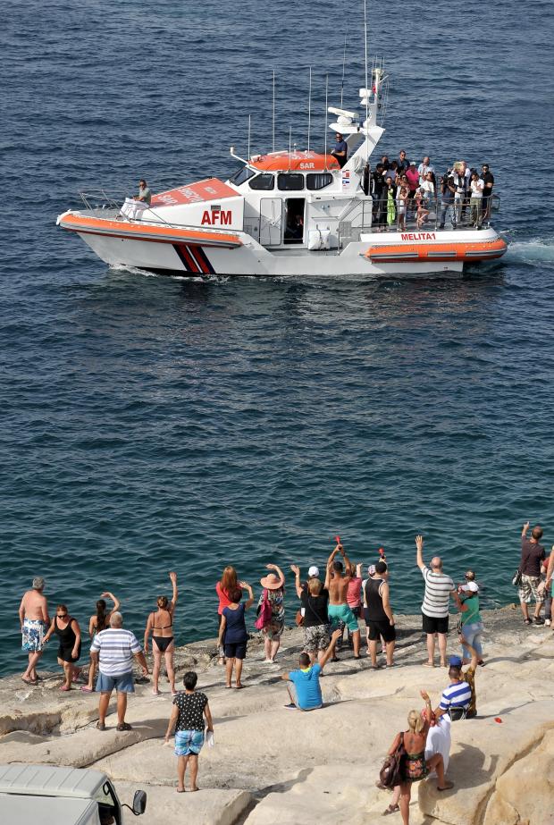 Michelle Muscat Accompanied by her Prime Minister husband Joseph Muscat, acknowledge the cheers from a crowd of supporters in Marsamxett harbour moments after Michelle completed her ten kilometer swim in aid of charity on July 20. Photo: Chris Sant Fournier