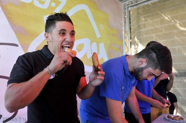 Students devour pastizzi as part of a pastizzi eating competition at the Freshers Week at the University of Malta on September 30. Photo: Chris Sant Fournier