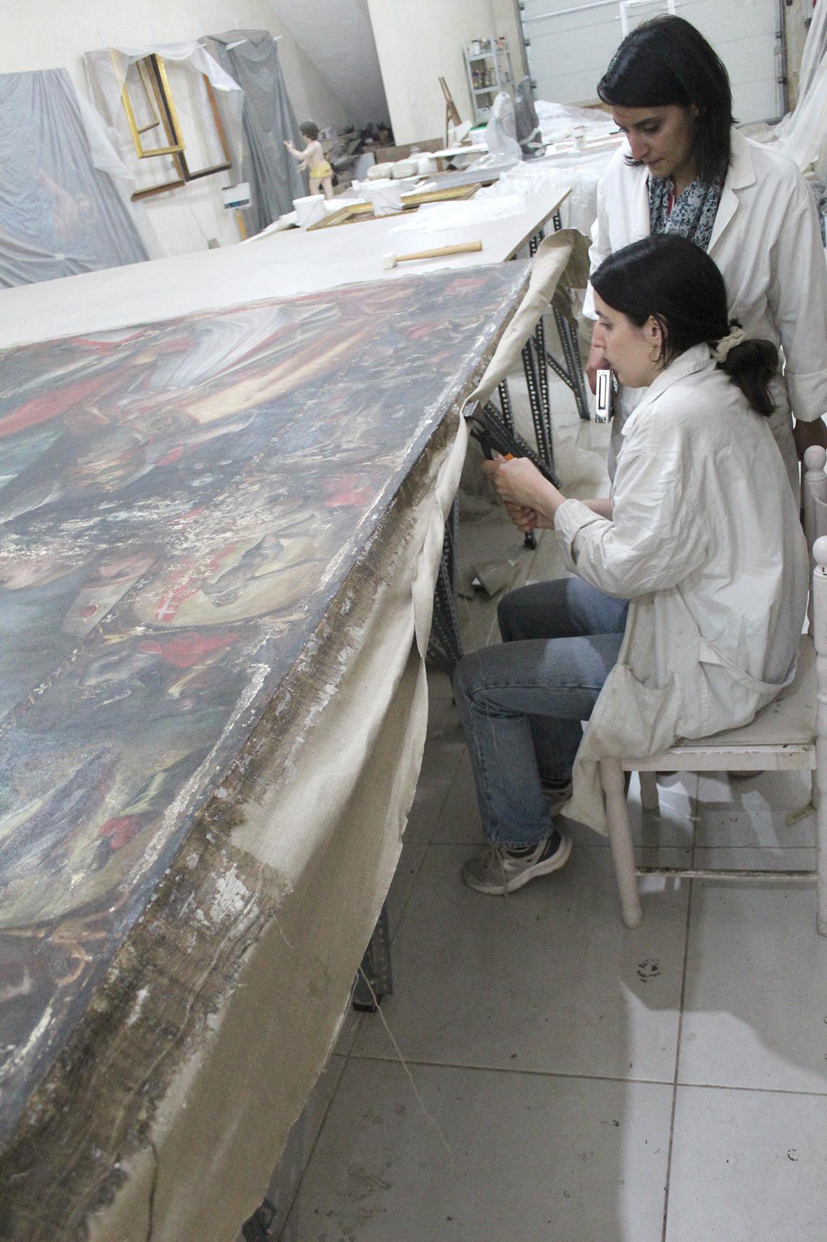 Re-stretching of the large-scale painting, following treatments of the canvas support. Photo: ASC Conservation Centre Ltd.