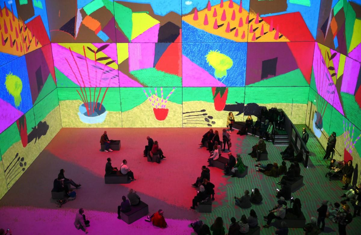 Visitors enjoying the immersive experience into Hockney's world.