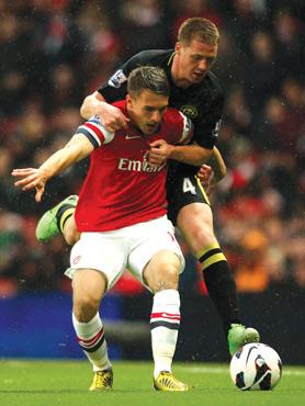 Arsenal&rsquo;s Aaron Ramsey holds back James McCarthy, of Wigan.