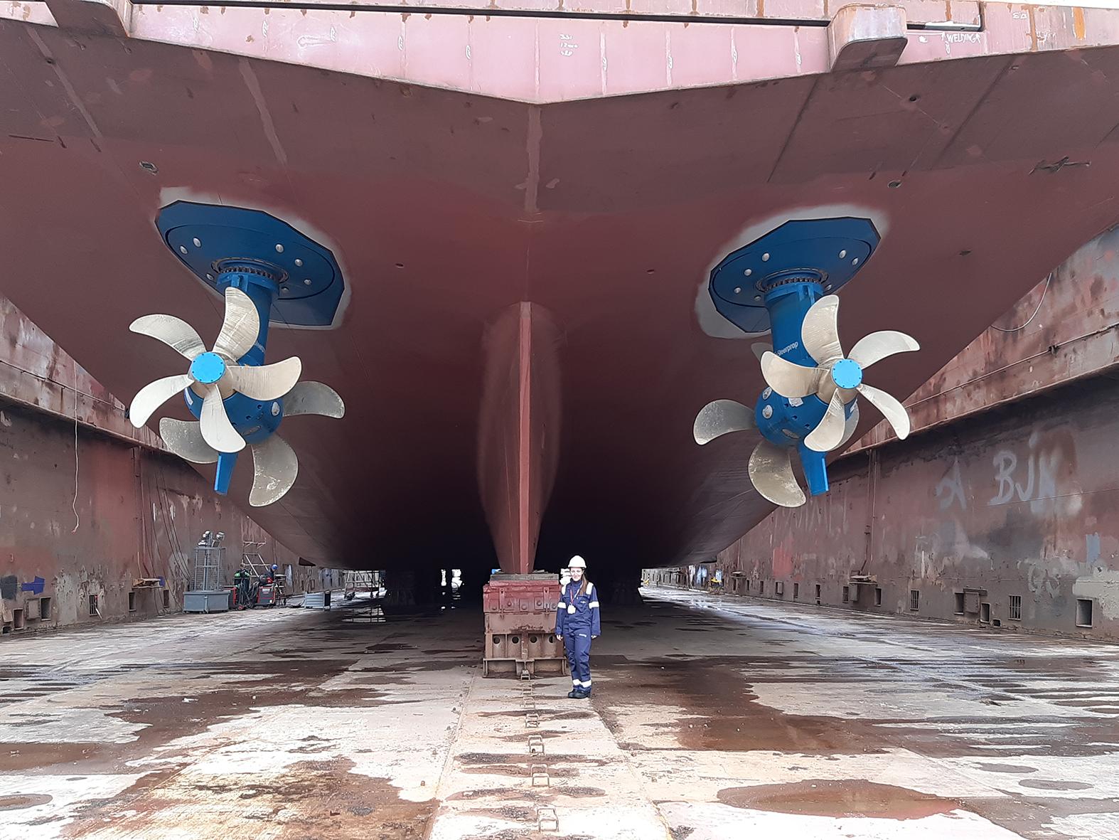 Agius stands underneath the massive <em>Celebrity Flora</em>, another one of the company&rsquo;s cruise liners.