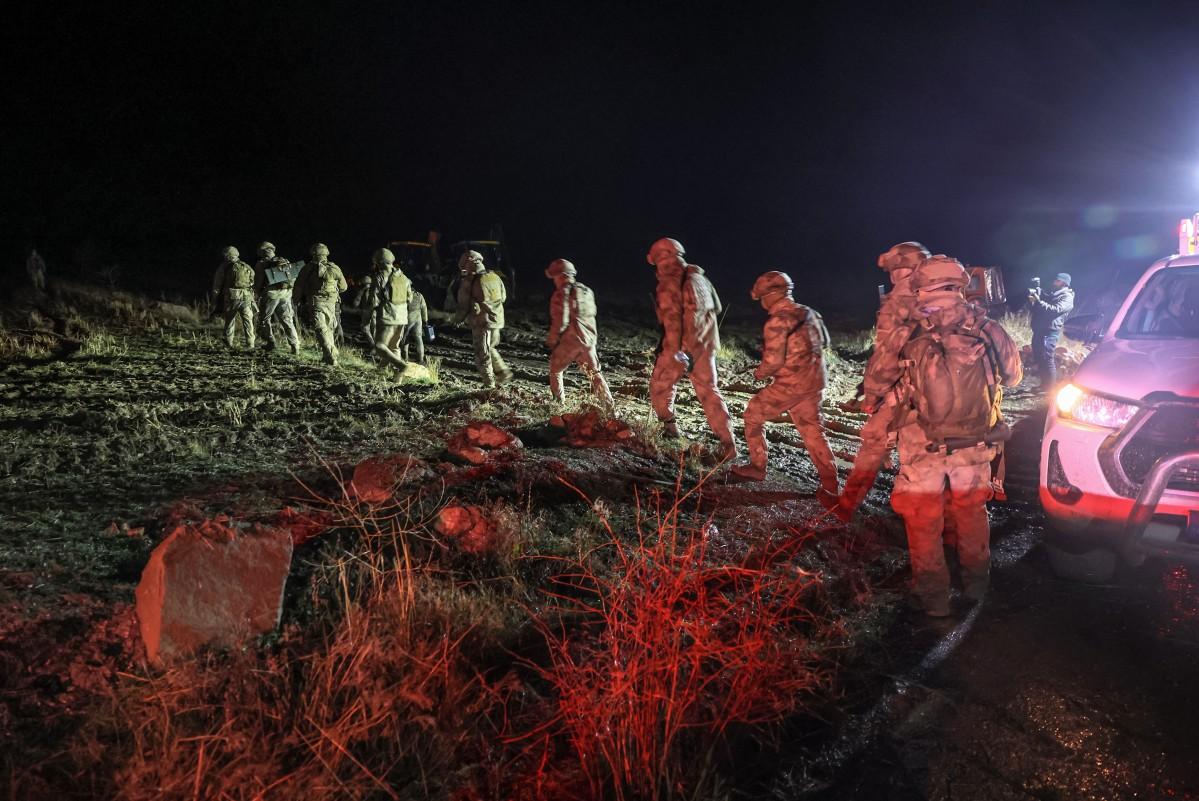 Soldiers patrol as search and rescue operations continue at the wreckage site. Photo: AFP