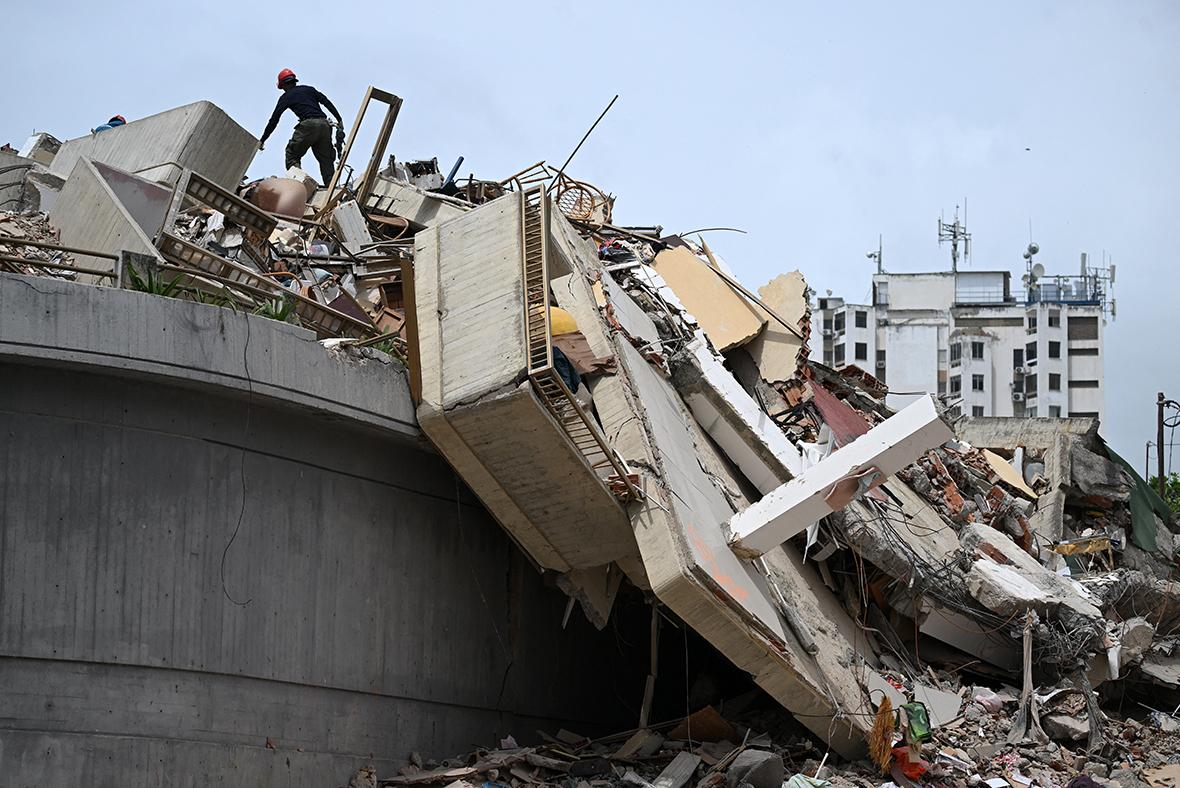 A rescue worker searches for victims amid the rubble in Macuto, Vargas state, Venezuela. Photo: AFP