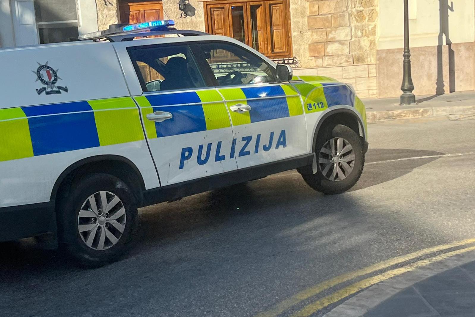 Police rushing past Żejtun Church to reach the site of the argument. Photo: Daniela Peresso