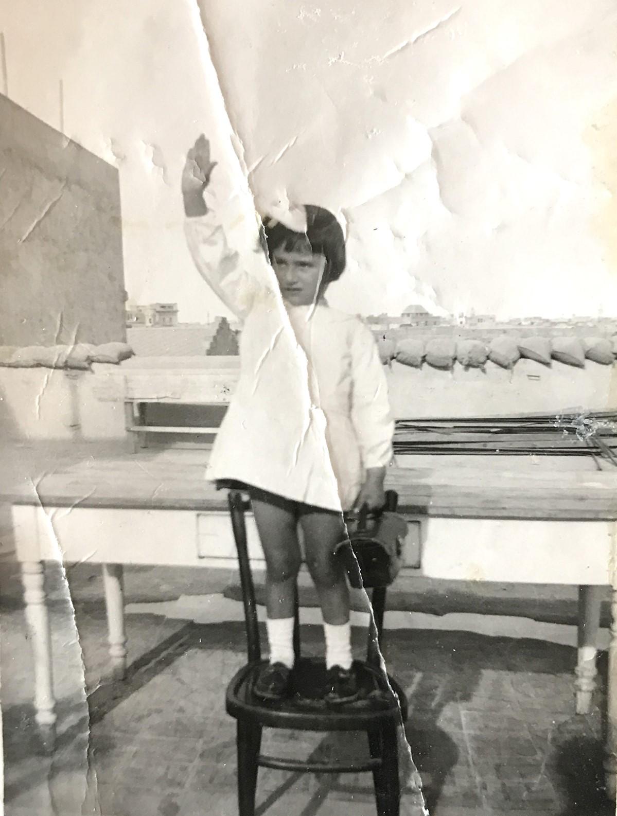 Peer pressure. Giovanna Cassar, unwillingly, performs the Roman salute in preparation for school. Photo: Family archive