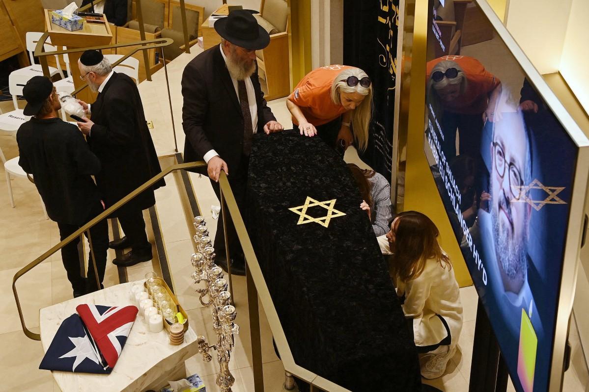 Relatives of rabbi Eli Schlanger, who was killed in the December 14 Bondi beach shooting attack, weep next to his coffin during his funeral. Photo: AFP