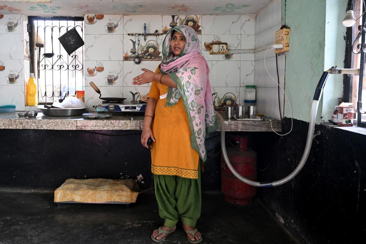 Gauri Devi, who cooks food using biogas, speaking during an interview with AFP at her residence in Uttar Pradesh's Bulandshahr district. Photo: AFP