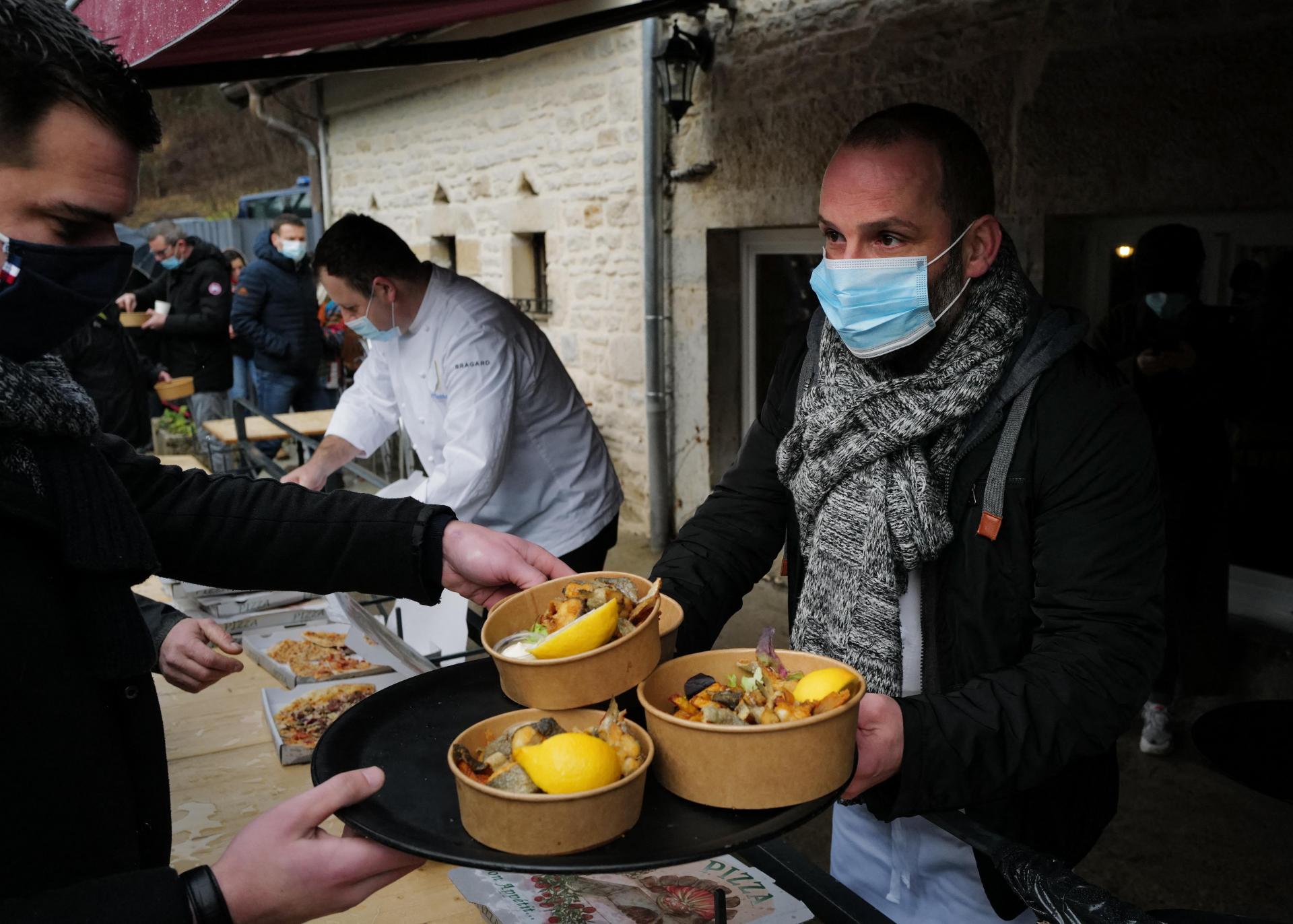 French chef Stephane Turillon serves meals outside his restaurant 'La source bleue' in Cusance, eastern France, on February 1, 2021, after he opened his restaurant despite the COVID-19 restrictions as an act of &ldquo;civil disobedience&rdquo;. Photo: AFP