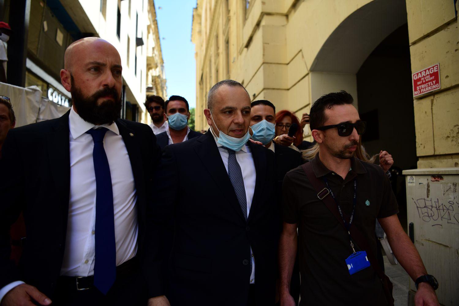 Keith Schembri (centre) taken to court in 2020.