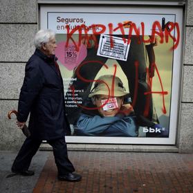 A man walks past graffiti sprayed on a bank window in Bilbao&rsquo;s Gran Via during a general strike called by Basque nationalist unions ELA and LAB in Spain. The graffiti reads &ldquo;Burn Capitalism&rdquo;. Photo: Vincent West/Reuters
