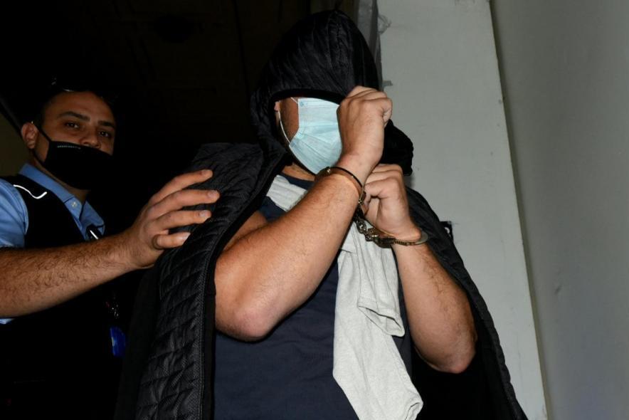Kristiansen hides his face as he is escorted to court to be arraigned in August 2020. Photo: Chris Sant Fournier