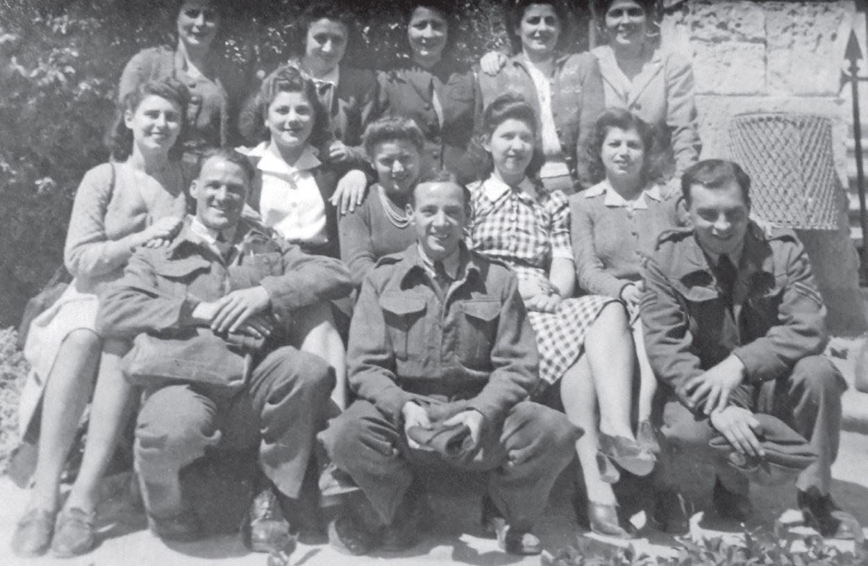 D Watch, 1944. Back: Not known, Sarah Demajo, Win Turk, Kay Xuereb, Carmen Borg. Middle: Stella Vella, Julie Xuereb, Mary Aitken, Lily Turk, not known. Front: Three men, not known.